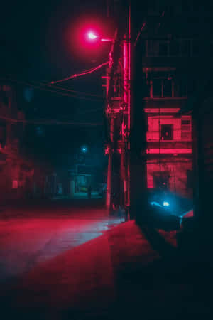 Neon Red Aesthetic Light Illuminating A Street Wallpaper