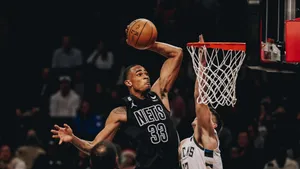 Nets Player Dunking During Game Wallpaper