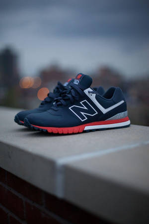 New Balance Shoe On Concrete Ledge Wallpaper