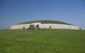 Newgrange With Grass Field Long Shot Wallpaper