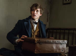 Newt_ Scamander_ Holding_ Magical_ Case Wallpaper