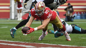 Nfl Footballer George Kittle On The Ball Wallpaper