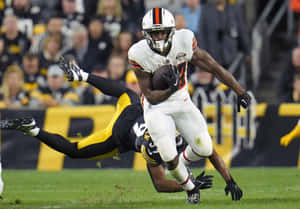 Nick Chubb Evading Tackle During Game Wallpaper