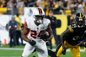 Nick Chubb Evading Tackle During Game Wallpaper