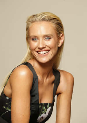 Nicky Whelan Striking A Pose In A Stylish Outfit Wallpaper