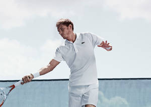 Nicolas Mahut Donned In Lacoste Sportswear, Displaying A Perfect Pose With His Tennis Racquet. Wallpaper