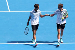 Nicolas Mahut Fist Bump With Partner Wallpaper