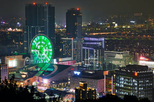 Night View Of The Bustling Cityscape Of Taipei With Miramar Ferris Wheel. Wallpaper