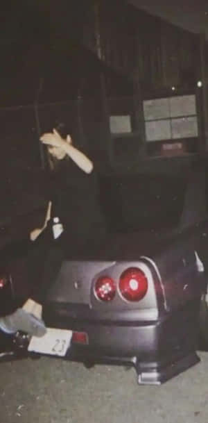 Nighttime_ J D M_ Car_and_ Person_ Pose.jpg Wallpaper