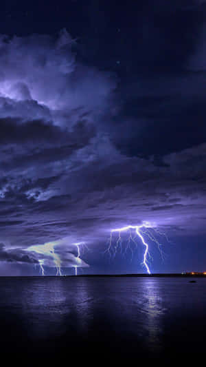 Nighttime Lightning Over Ocean Wallpaper