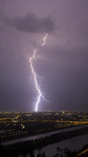 Nighttime Lightning Strike Over Cityscape Wallpaper