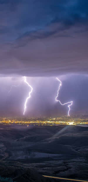 Nighttime Lightning Strike Over Cityscape Wallpaper