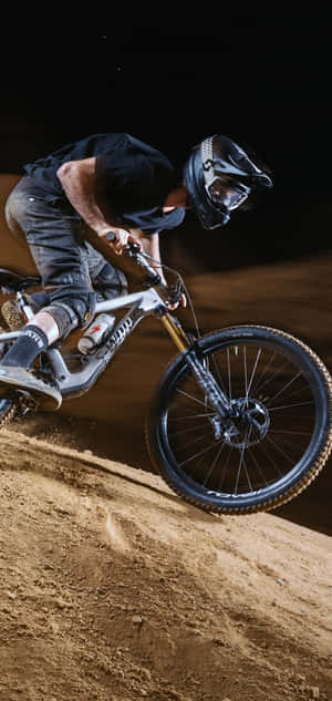 Nighttime Mountain Biking Action Wallpaper