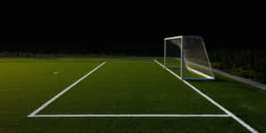 Nighttime Soccer Field Goal Post Wallpaper