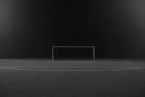 Nighttime Soccer Goal Empty Field Wallpaper