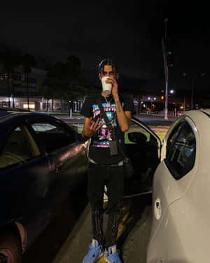 Nighttime Urban Style Man With Cup Wallpaper