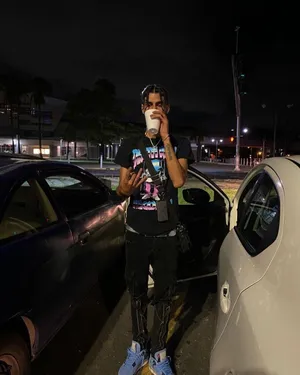 Nighttime Urban Style Man With Cup Wallpaper