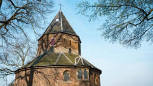 Nijmegen Historical Church Surroundedby Trees Wallpaper