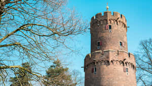 Nijmegen Historical Tower Against Blue Sky Wallpaper