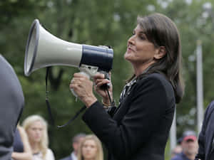 Nikki Haley Addressing Crowd With Megaphone Wallpaper