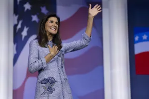 Nikki Haley Raising Her Hand In Determined Gesture Wallpaper