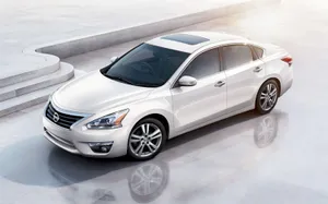 Nissan Altima In Stunning Red On A Scenic Drive Wallpaper