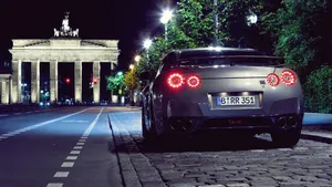 Nissan Gtr Car Parked Near The Historical Gate Wallpaper