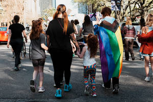 Non-binary Parent Engaged In Fun Time With Kids Wallpaper