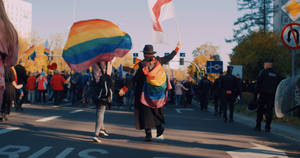 Non-binary Raising Flags Rallying Wallpaper