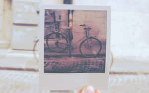 Nostalgic Moment With Vintage Polaroid Camera Wallpaper