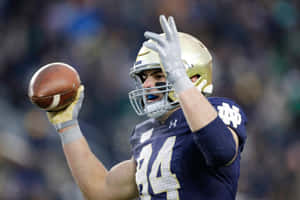 Notre Dame Football Player Catching Ball Wallpaper