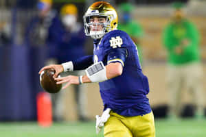 Notre Dame Quarterback Ian Book Action Shot Wallpaper