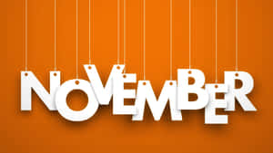 November Word Hanging On Strings On Orange Background Wallpaper