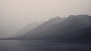 Obscure Foggy Mountains And Lake Wallpaper