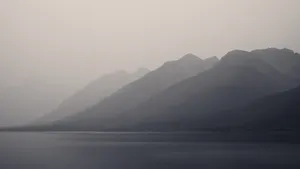 Obscure Foggy Mountains And Lake Wallpaper