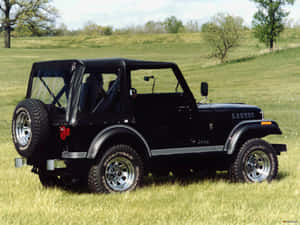 Off-road Beast - Jeep Cj Amidst The Rocky Terrain Wallpaper