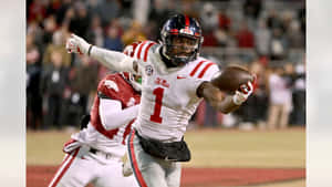 Ole Miss_ Football_ Player_ Catching_ Ball Wallpaper