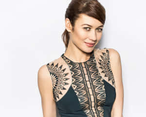 Olga Kurylenko Striking A Pose In A Fashionable Outfit Wallpaper