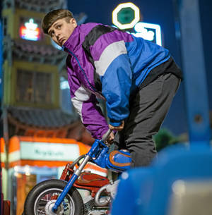 Oliver Tree Riding A Miniature Motorbike Wallpaper