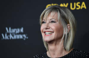 Olivia Newton-john, A Stellar Performing Artist Wallpaper