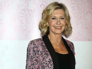 Olivia Newton-john Elegance On Stage Wallpaper