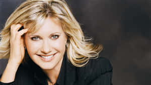 Olivia Newton John Hand In Hair Pose Wallpaper