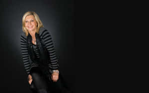 Olivia Newton John In Dark Background Wallpaper