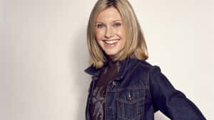 Olivia Newton John Wearing Denim Jacket Wallpaper