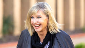 Olivia Newton John With Big Smile Wallpaper