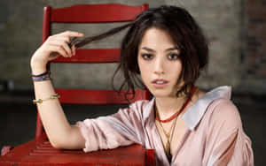 Olivia Thirlby Striking A Pose Against A Colorful Backdrop Wallpaper