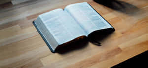 Open Bibleon Wooden Table Wallpaper