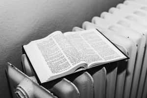 Open Black And White Book On A Wooden Surface Wallpaper