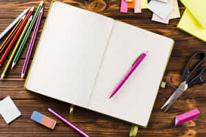 Open Notebookwith Stationery Items Wallpaper