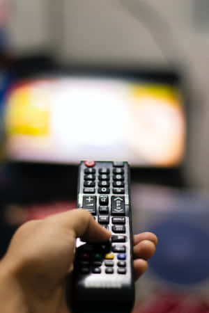 Operating A Tv Using Remote Control Wallpaper